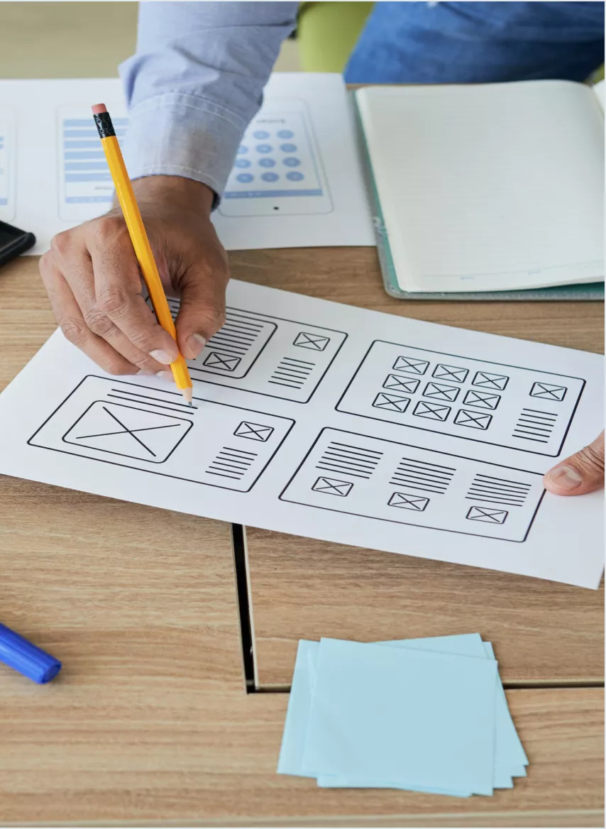 Designers reviewing wireframes and site structure on a laptop